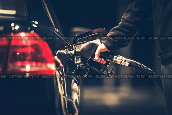 Car Refueling at the Gas Station. Gas Pump Nozzle. Стоковое фото, агентство Ingram Publishing / Фотобанк Лори