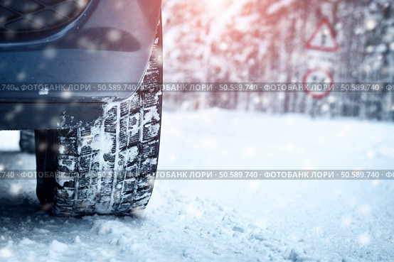 Car tires on winter road covered with snow. Vehicle on snowy alley in the morning at snowfall. Car tires on winter road. Стоковое фото, агентство Ingram Publishing / Фотобанк Лори