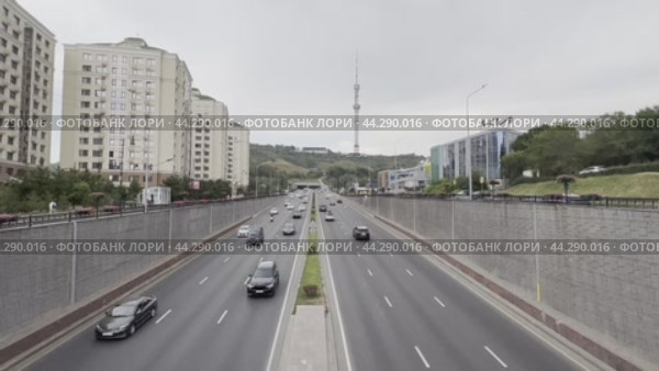 Car traffic on Dostyk Avenue against the backdrop of Kok-Tobe Mountain and the city tower. Kazakhstan. Alama-ata. 24.08.2024. Редакционное видео, видеограф Ярославский Максим / Фотобанк Лори