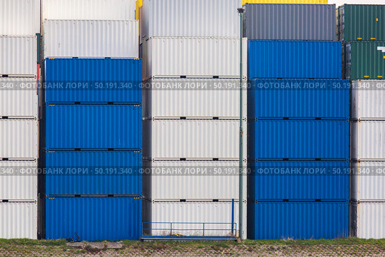 Cargo Containers Goods Stack at the Pier docks port waiting for international sea freight transportation in Rotterdam Port of Netherlands. Стоковое фото, агентство Ingram Publishing / Фотобанк Лори