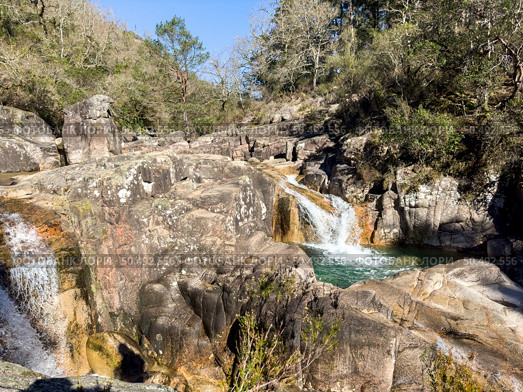 Cascata do Tahiti is also known as Fecha das Barjas and is a waterfall with several natural pools where you can swim. It is located in the Peneda Geres National Park in the north of Portugal. Стоковое фото, агентство Ingram Publishing / Фотобанк Лори