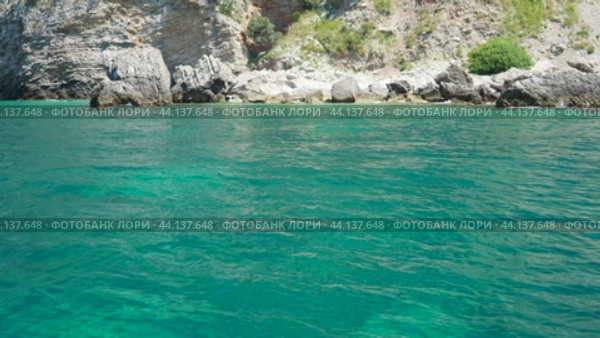 Cave Pecin bay Budva Montenegro. Rocks near Buljarica. Stones, inaccessible rocks. Flysch marine rocks lithological layers. Adriatic Mediterranean sea blue green water. Nature park Katici. (2024 год). Стоковое видео, видеограф Юлия Петровская / Фотобанк Лори