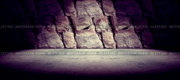 Cement floor and rock wall background and spotlight. Concrete and rock floor background. Стоковое фото, агентство Ingram Publishing / Фотобанк Лори