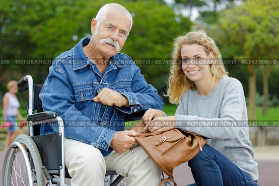 cheerful senior man in wheelchairs with daughter. Стоковое фото, агентство Ingram Publishing / Фотобанк Лори