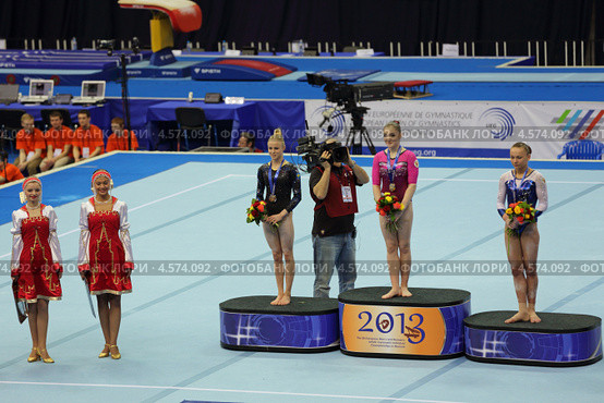 Чемпионат Европы по спортивной гимнастике 2013 года. Москва, СК "Олимпийский". Победители состязаний в на разновысоких брусьях - Алия Мустафина, Йонна Адлертег и Мария Пасека. Редакционное фото, фотограф Игорь Долгов / Фотобанк Лори