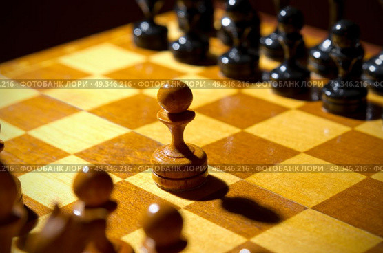 Chessboard with figures on dark background. Стоковое фото, агентство Ingram Publishing / Фотобанк Лори