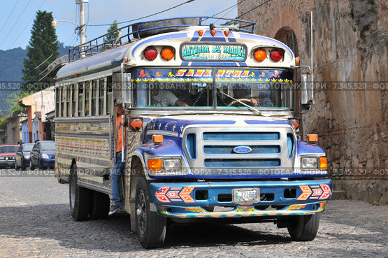 Chicken bus (Camioneta) colloquial name a colorful modified and decorated bus that transports goods and people between communities in Honduras and Guatemala.Guatemala, Antigua, typical colorful and decorated bus. Редакционное фото, агентство BE&W Photo / Фотобанк Лори