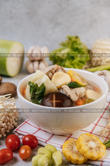 Chicken soup with corn, shiitake mushroom, enoki mushroom, and carrot. Стоковое фото, агентство Ingram Publishing / Фотобанк Лори