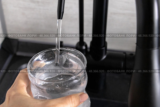 Clean filtered water from flow-through three-stage purifying water filtration system. Стоковое фото, фотограф Наталья Симакова / Фотобанк Лори