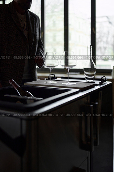 Clean wine glasses and decanter are on the table of a special wine cabinet, stylish table setting, ice, light from window, decoder and degasser. Стоковое фото, фотограф Vladimir Drozdin / Фотобанк Лори
