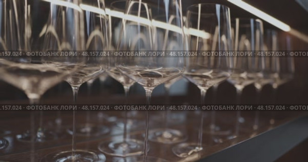Clean wine glasses are in the wine cabinet in restaurant, local illumination. Стоковое видео, видеограф Vladimir Drozdin / Фотобанк Лори