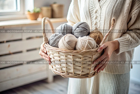 Close-up. A woman with balls of yarn in white and beige tones in her hands. Needlework, knitting. Winter season, small business, handmade clothes. Стоковое AI-изображение, AI-художник Photojuli / Фотобанк Лори
