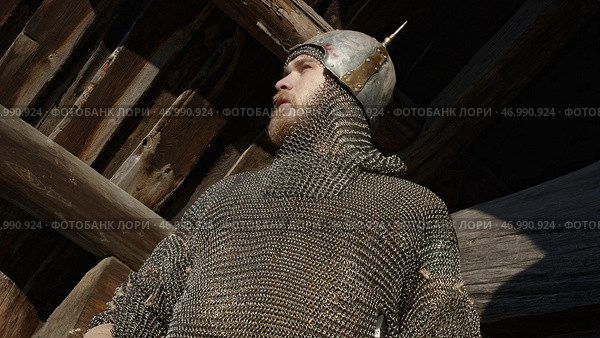 Close up of a warrior in chainmail armor whistling with his fingers. Стоковое фото, фотограф David Kashakhi / Фотобанк Лори