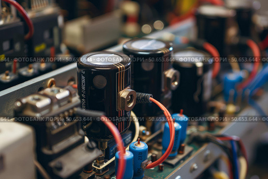 Close up of an electronic circuit board with capacitors, resistors, and wires. Стоковое AI-изображение, AI-художник Иван Рябоконь / Фотобанк Лори