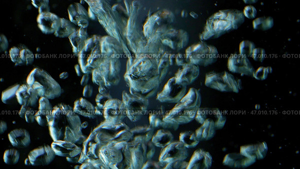 Close up of bubbles of air underwater on a black background. Стоковое фото, фотограф David Kashakhi / Фотобанк Лори