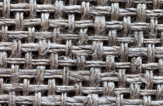 Close-up of linen canvas for hand cross stitch or other embroidery. Gray natural textile background of interwoven threads with square cells. Basis for needlework and hobbies. Flat lay, macro, top view, mockup. Стоковое фото, фотограф Виктория Катьянова / Фотобанк Лори