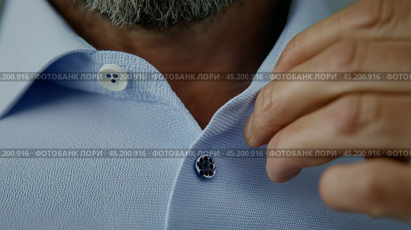 close up of male hands buttoning a button on a blue shirt. Стоковое AI-изображение, AI-художник Margarita Davchenko / Фотобанк Лори