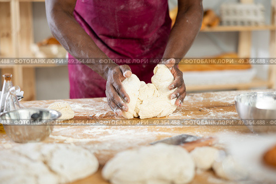 Close-up of professional African baker kneading dough. Стоковое фото, фотограф Яков Филимонов / Фотобанк Лори