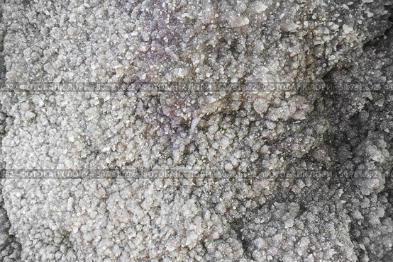 Close-up of salt or mineral crystal formation resembling a stalagmite surface with dense texture, captured inside a natural cave or underground chamber. Стоковое фото, фотограф Татьяна Терехина / Фотобанк Лори
