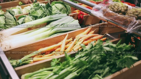 Colorful market counter with large assortment of farm fresh organic vegetables for sale. Стоковое видео, видеограф Яков Филимонов / Фотобанк Лори
