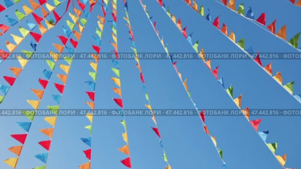Colorful triangular flags waving in the wind in Moscow. Стоковое видео, видеограф Mikhail Davidovich / Фотобанк Лори