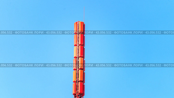 Communication tower close-up. Telecommunications Base Station Tower. Close up antenna repeater cell tower in city background of the sky. Mobile communication tower. Стоковое фото, фотограф Скрипачев Антон / Фотобанк Лори