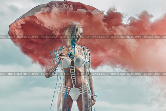 Conceptual portrait of a blond lady holding smoky umbrella. Стоковое фото, агентство Ingram Publishing / Фотобанк Лори