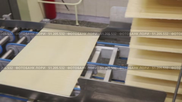 conveyor at a confectionery factory coating wafer plates with chocolate mass and assembling wafers. Стоковое видео, видеограф Алексей Сергеев / Фотобанк Лори