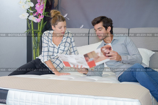 couple testing bed for possible purchase. Стоковое фото, агентство Ingram Publishing / Фотобанк Лори