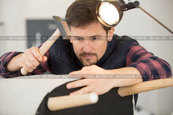 craftsman engaged in chair repair. Стоковое фото, агентство Ingram Publishing / Фотобанк Лори