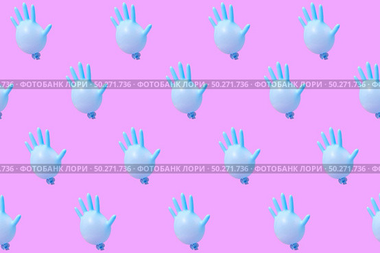 Creative pattern from blue rubber surgical gloves as flying balloons against a hot pink background.. Pattern from blue latex glove as balloons on hot pink background. Стоковое фото, агентство Ingram Publishing / Фотобанк Лори