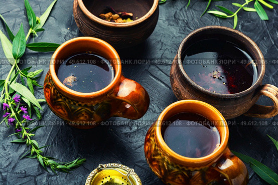 Cup of herbal tea on the table. Ivan tea or fireweed.Herbal medicine. Aromatic fireweed tea. Стоковое фото, агентство Ingram Publishing / Фотобанк Лори
