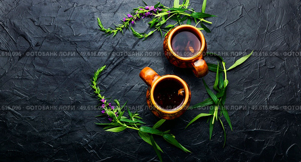 Cup of herbal tea on the table. Ivan tea or fireweed.Willow-herb.Copy space. Aromatic fireweed tea. Стоковое фото, агентство Ingram Publishing / Фотобанк Лори