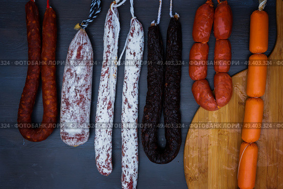 Cured meat and sausages hanging a rack at market.. Cured meat and sausages. Стоковое фото, агентство Ingram Publishing / Фотобанк Лори