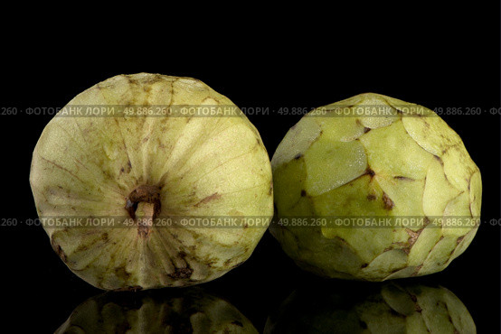 Custard apple, also known as Bullocks or Bulls Heart.On black with reflection. Стоковое фото, агентство Ingram Publishing / Фотобанк Лори