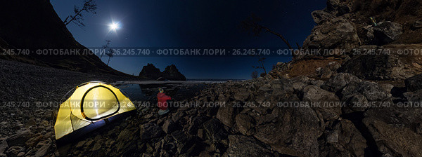 Cylindrical 360 panorama of man at tent on stone beach on shore of Lake Baikal at night. Стоковое фото, фотограф Zakirov Aleksey / Фотобанк Лори