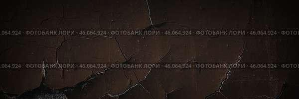 Dark wide panoramic background. Peeling paint on a concrete wall. Dark grunge texture of old cracked flaking paint. Weathered rough painted surface. Patterns of cracks. Darkness background for design. Стоковое фото, фотограф Андрей Степанов / Фотобанк Лори