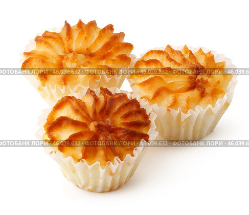 Delicious coconut macaroons with a golden brown crust arranged on a white surface for an enticing display. Стоковое фото, фотограф Сергей Толмачёв / Фотобанк Лори