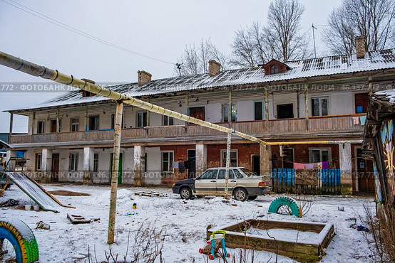 Детская площадка под теплотрассой на фоне дома с галерейной планировкой. Редакционное фото, фотограф Илья Старков / Фотобанк Лори