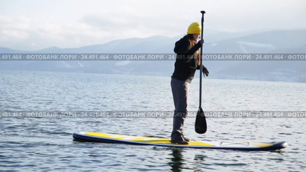 Девушка плавает на sup board по зимнему озеру в Сибири. Озеро Байкал. Стоковое видео, видеограф Виталий Зверев / Фотобанк Лори