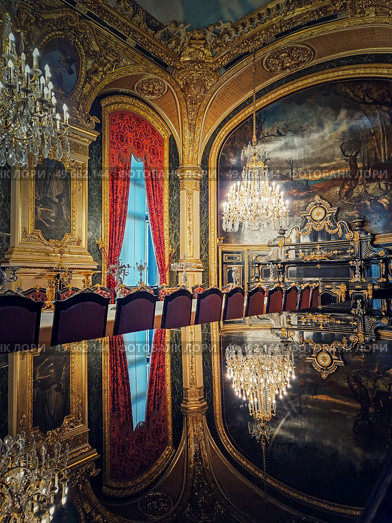 Dining room of Napoleon III at the Louvre Museum. Beautiful decorated royal family apartments, ornate with gold, mural paintings and crystal chandeliers suspended from ceiling. Стоковое фото, агентство Ingram Publishing / Фотобанк Лори