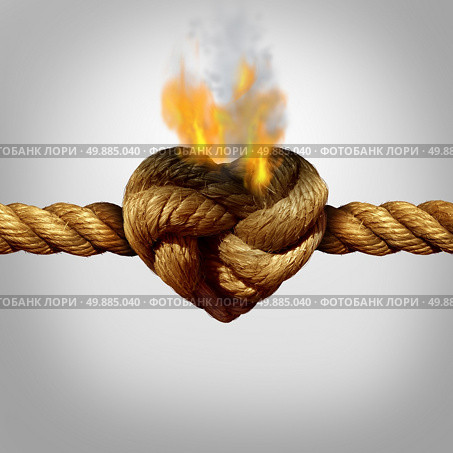Divorce and separation concept as a rope with a burning knot shaped as a love heart as a relationship problem symbol or infidelity crisis icon between a couple. Стоковое фото, агентство Ingram Publishing / Фотобанк Лори