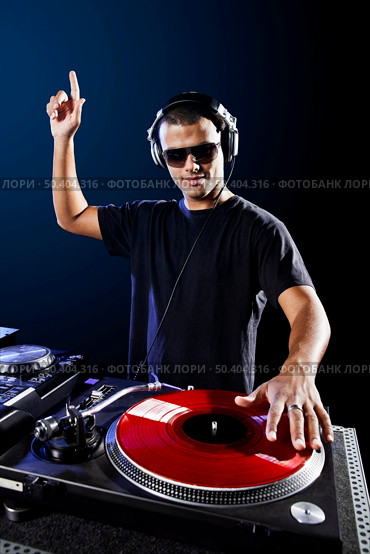 Dj playing disco electro music in a concert. Стоковое фото, агентство Ingram Publishing / Фотобанк Лори