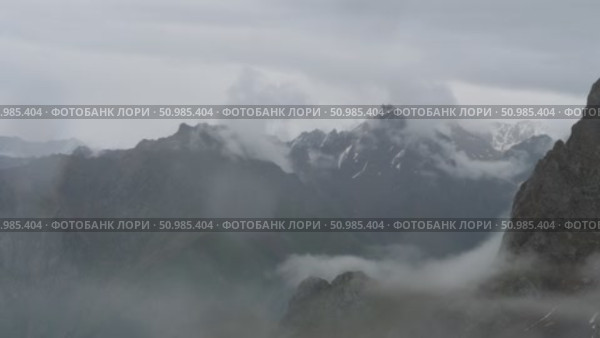 Dramatic view of Medeo mountain peaks under low clouds. Стоковое видео, видеограф Игорь Жоров / Фотобанк Лори
