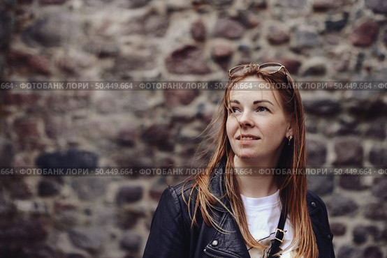 Dreamy Gaze Towards Future Possibilities Against a Stone Wall in Old Town. Стоковое фото, фотограф Aleksandr Golubev / Фотобанк Лори
