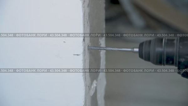 Drilling a concrete wall with a drill to attach a door frame. Repair work. Drilling a hole. Accelerated shooting. Стоковое видео, видеограф Дмитрий Кобзев / Фотобанк Лори