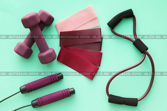 Elastic bands, dumbbells, skipping rope and fitness expander on color background. Стоковое фото, фотограф Pixel_shot / Фотобанк Лори