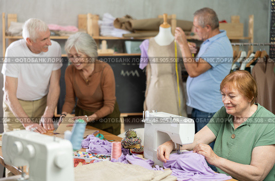 Elderly men and women spending time sewing in workroom. Стоковое фото, фотограф Яков Филимонов / Фотобанк Лори