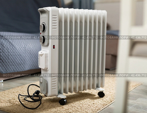 Electric oil-filled convection heater used in domestic heating. Стоковое фото, фотограф Яков Филимонов / Фотобанк Лори