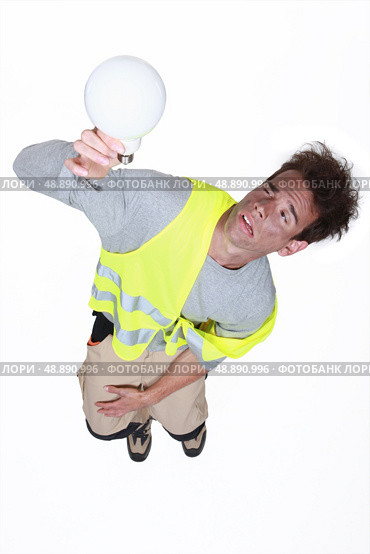Electrocuted man holding a light bulb. Стоковое фото, агентство Ingram Publishing / Фотобанк Лори